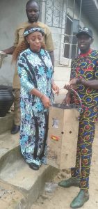 NUJ Chair, receiving Atmosfair Save80 Clean Cookstove from Hon. Ebimotimi Paulson Leghemo, while Comrade Confidence Mac-Eteli looks on
