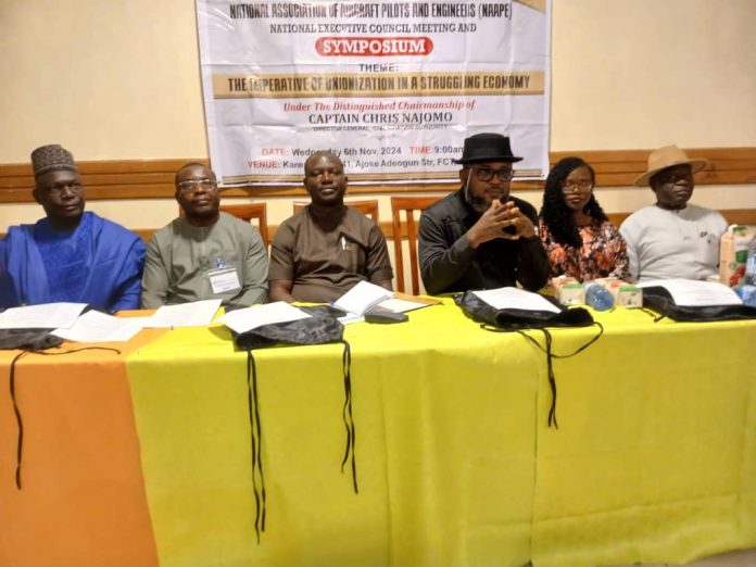 L-R: Former General Manager, Human Resources, Nigerian Civil Aviation Authority (NCAA), Chief Anthony Ayasal, representative of the Rector and Dean, Aircraft Maintenance Engineering School, Nigerian College of Aviation Technology (NCAT) Engr. Daniel Lawrence, President, National Association of Aircraft Pilots (NAAPE), Abednego Galadima, representative of the Director General and Director, Public Affairs and Consumer Protection, NCAA, Mr Michael Achimugu, Human Resources Officer, Arik Air, Idaresit Okon Essien and former NAAPE President, Engr. Kyari Sheri Ayabu at a one-day symposium organised by NAAPE with the theme "The Imperative of Unionisation in a Struggling Economy" in Abuja on Wednesday. L-R: Former General Manager, Human Resources, Nigerian Civil Aviation Authority (NCAA), Chief Anthony Ayasal, representative of the Rector and Dean, Aircraft Maintenance Engineering School, Nigerian College of Aviation Technology (NCAT) Engr. Daniel Lawrence, President, National Association of Aircraft Pilots (NAAPE), Abednego Galadima, representative of the Director General and Director, Public Affairs and Consumer Protection, NCAA, Mr Michael Achimugu, Human Resources Officer, Arik Air, Idaresit Okon Essien and former NAAPE President, Engr. Kyari Sheri Ayabu at a one-day symposium organised by NAAPE with the theme "The Imperative of Unionisation in a Struggling Economy" in Abuja on Wednesday.