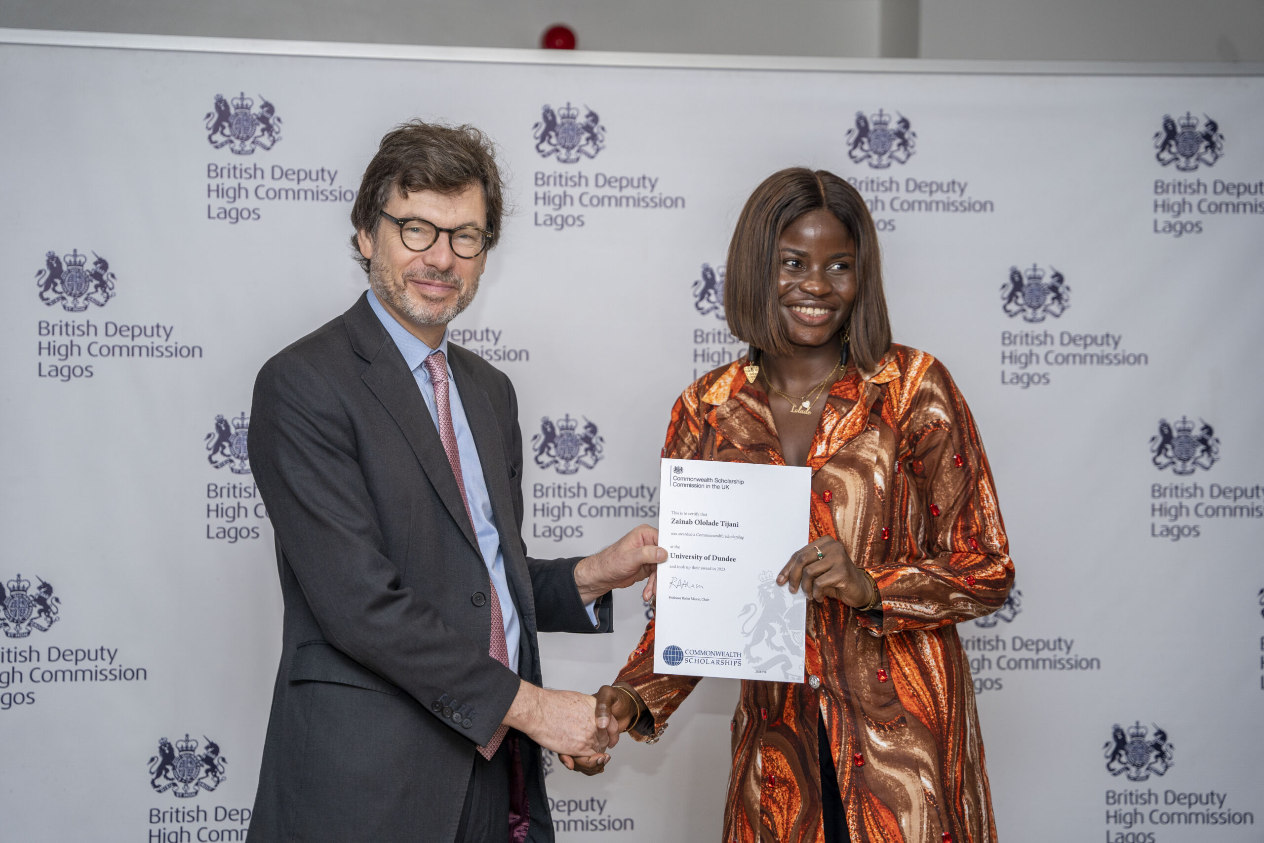 British Deputy High Commisioner, Jonny Baxter presenting a completion certificate to a Commonwealth scholar in Lagos