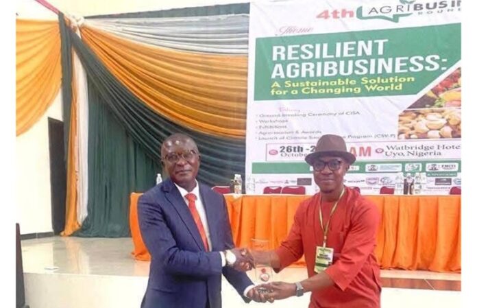 Mr Michael Udofia, receiving an award during the 4th Agribusiness Roundtable in Uyo.