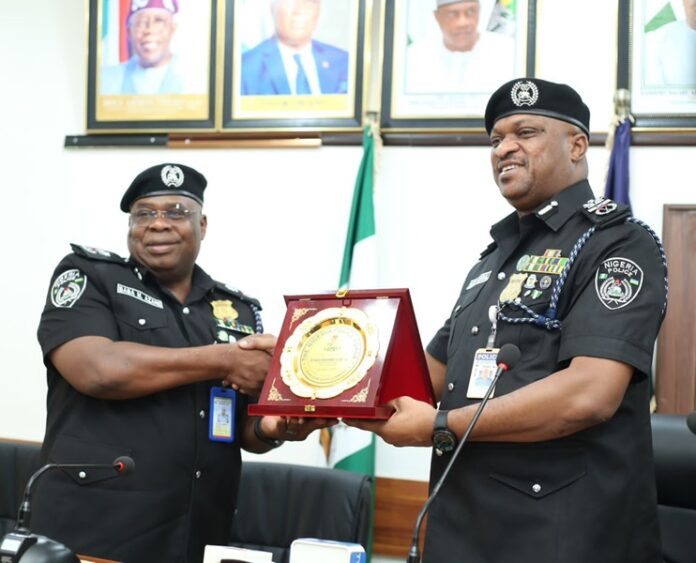 pic of the AIG, Zone 6, Auwal Musa Muhammed receiving a plaque from the Akwa Ibom State police Police Commissioner, Baba Mohammed Azare, during his visit to the command on Monday. pic of the AIG, Zone 6, Auwal Musa Muhammed receiving a plaque from the Akwa Ibom State police Police Commissioner, Baba Mohammed Azare, during his visit to the command on Monday.