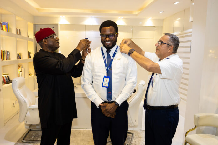 Chairman and Chief Executive Officer, Dr Allen Ifechukwu Onyema (left) and Deputy Head of Training, Captain José Calvino (right) decorating the newly elevated captain, Solomon Ayegba at the airline’s corporate headquarters in Ikeja, Lagos recently.