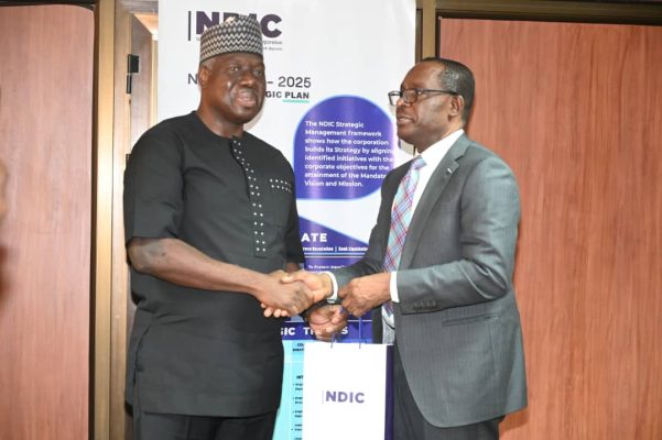 L – R: COLLABORATION TOWARD SAFER PAYMENT SYSTEM: Managing Director/CE, Nigeria Interbank Settlement System (NIBSS), Mr Bola Enigbokan, receiving the Corporation’s research publications from the Managing Director/CE, Nigeria Deposit Insurance Corporation, Mr. Thompson Oludare Sunday during a courtesy visit by NIBSS Management team to the NDIC. L – R: COLLABORATION TOWARD SAFER PAYMENT SYSTEM: Managing Director/CE, Nigeria Interbank Settlement System (NIBSS), Mr Bola Enigbokan, receiving the Corporation’s research publications from the Managing Director/CE, Nigeria Deposit Insurance Corporation, Mr. Thompson Oludare Sunday during a courtesy visit by NIBSS Management team to the NDIC.