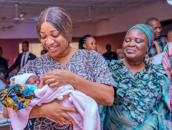 coordinator of the office of the first lady, Mrs Helen Obareki, with the new year baby coordinator of the office of the first lady, Mrs Helen Obareki, with the new year baby