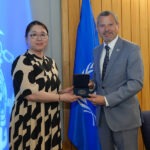 Africa Blue Economy Roundtable Congratulates Kitada On Receiving 2026 IMO Gender Equality Award In London Two officials in a formal award ceremony exchanging a medal box, with a UN flag in the background.