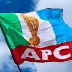 Water Resources Minister Preaches Peace As Reps Aspirants Await APC Primaries Results In Benue Flag of the APC political party fluttering in the wind against a blue sky, featuring a torch emblem and bold 'APC' lettering on a red stripe.