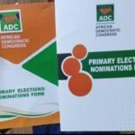 Ogun 2027: US-Based Physician Dr Odusina Formalises Guber Bid On ADC Platform Two hands hold up ADC political party nomination forms, one orange and one white/green, with the African Democratic Congress logo and 'Primary Elections/Nominations Form' text visible.
