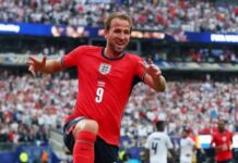 England Finish Perfectly As Bellingham, Kane Sink Panama To Seal Group L Supremacy England forward in red jersey with number 9 celebrating a goal on a packed stadium.