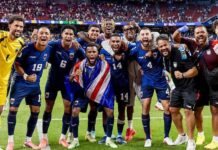 Cape Verde Make World Cup History Despite Goalless Draw With Saudi Arabia Soccer team in blue celebrating together on the field after a win, arms around each other in a stadium.