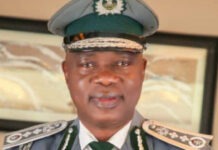 Tinubu Extends Adeniyi’s Tenure as Customs CGC to February 2027 Portrait of a senior police officer in full dress uniform, green peaked cap, and decorative shoulder insignia, facing the camera.