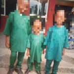 Police Foil Child Trafficking Attempt, Rescue Three Abducted Children In Akwa Ibom Three people standing outside a building, wearing matching green outfits: an adult on the left and two children.