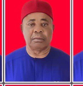 IMG_6584 Portrait of a man wearing a red cap and royal blue traditional outfit, against a bright red background.