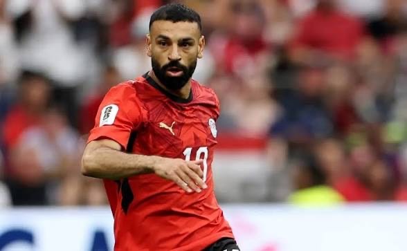 salah - THEWILL NEWS MEDIA Soccer player in a red jersey with number 10, mid-action on the field during a match.