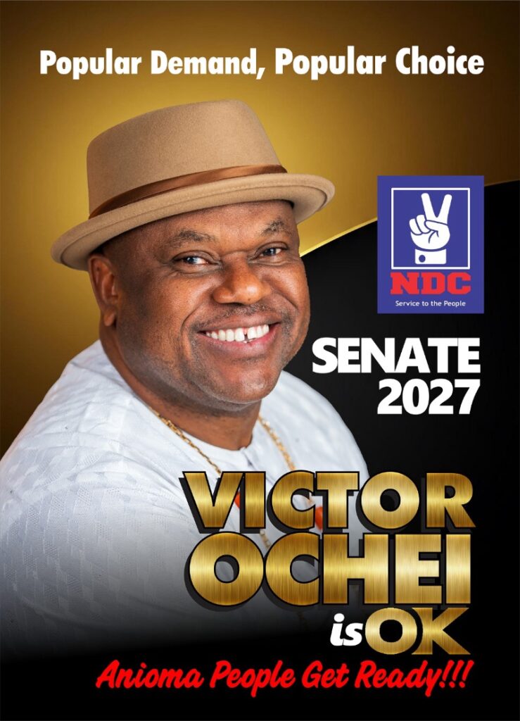 Campaign poster showing a smiling man in a tan hat; bold 'VICTOR OCHEI' name, 'SENATE 2027', and a blue NDC logo are featured beside gold text.