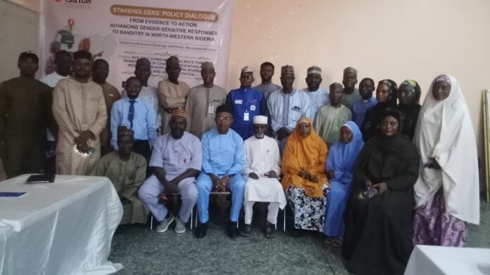 oplus_0 Group of people posing for a photo at a stakeholders' policy dialogue event, with a banner in the background.