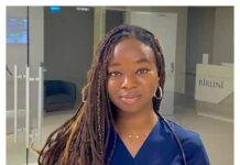 Nigeria Mourns 23-Year-Old Medical Graduate Killed in Russian Bombardment Portrait of a healthcare professional with long braided hair, wearing navy scrubs and a stethoscope, standing in a modern clinic lobby.