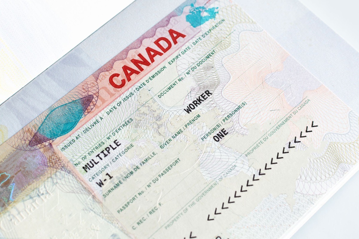 Canadian working visa in passport closeup. Immigration to Canada concept. - THEWILL NEWS MEDIA Canadian working visa in passport closeup. Immigration to Canada concept.