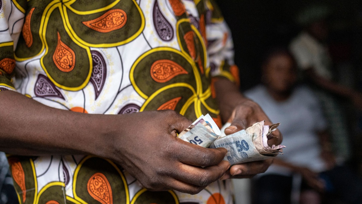 Cash - vendor counts old and newly introduced Nigerian Naira banknotes - THEWILL NEWS MEDIA Cash - vendor counts old and newly introduced Nigerian Naira banknotes