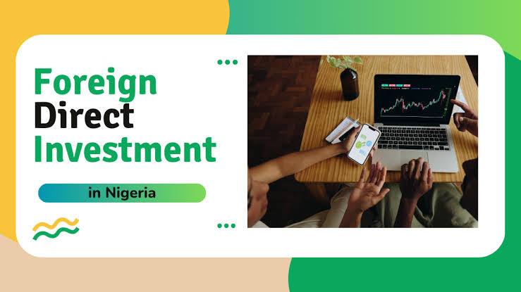 Banner promoting Foreign Direct Investment in Nigeria, with bold text and a desk scene showing a laptop and a phone displaying a chart.
