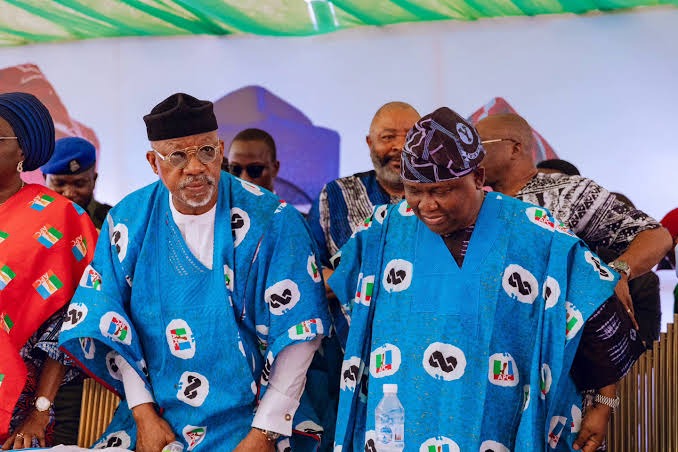 Ogun 2027: Abiodun Presents Adeola To Ijebu Royal Fathers, Seeks Support For APC Ticket Ahead Of Election Group of men in blue traditional outfits at a formal ceremony, some wearing hats and standing behind a table.