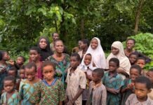 THEWILL EDITORIAL: After 56 days in Captivity, Time to Smile Again Group of African children and women standing together outdoors in a green, forested area.