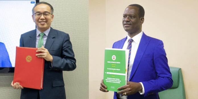 Nigeria’s Minister of Finance and Coordinating Minister of the Economy,. Taiwo Oyedele, and Hong Kong's Secretary for Financial Services and the Treasury, Christopher Hui during the signing of the agreement. Two men in suits hold official folders: one with a red binder, the other with a green booklet, posing for a photo in a formal setting.