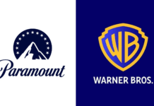 12 U.S. States Sue To Block Paramount–Warner Bros. Discovery Mega Merger Split image showing two film logos: left is Paramount with mountain peak, circular star ring and script 'Paramount'; right is Warner Bros. shield logo on blue with gold outline and 'WARNER BROS.' text.