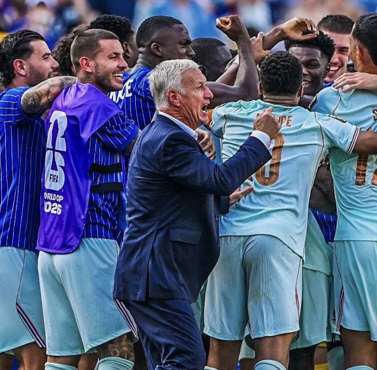 France have won all six of their matches at the 2026 FIFA World Cup, emerging as one of the tournament's strongest title contenders. - THEWILL NEWS MEDIA Coach in a dark suit leads a jubilant soccer team in light-blue kits during a post-match celebration on the field.