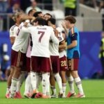 5 Reasons Spain Outclassed France To Reach 2026 FIFA World Cup Final Soccer players in white and maroon jerseys huddle together on the green pitch, Ferran Torres wearing number 7 at the center.