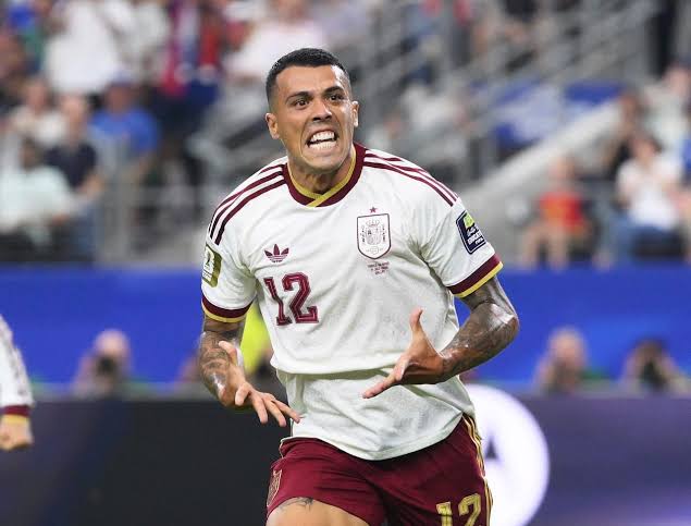 Spain national team footballer wearing number 12 celebrates a goal during a match on the field.