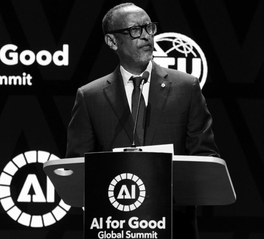 Speaker at a podium delivering a talk at the AI for Good Global Summit, with AI for Good logos in the background (black-and-white photo).