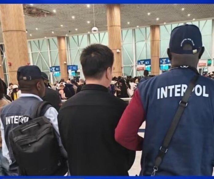 Chinese fugitive, Cai Jinlian (centre), is escorted by operatives of INTERPOL National Central Bureau (NCB), Abuja, during his transfer for extradition to Shanghai, China,