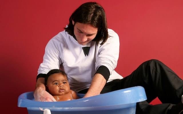 From a UNICEF charity photoshoot in 2007 to the 2026 FIFA World Cup final, Lionel Messi and Lamine Yamal's extraordinary connection has become one of football's most captivating stories. (Photo Credit: Getty Images/FC Barcelona/Joan Monfort) Parent bathing a baby in a blue plastic tub on the floor, against a red wall.