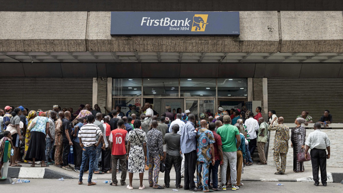 People queue outside a bank