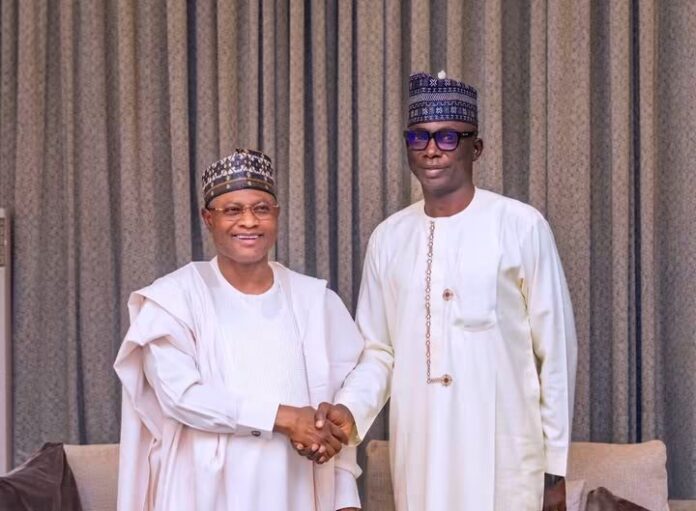 Uba Sani (left), shakes hands with Jerry Adams