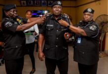 Akwa Ibom Police Tighten Security Strategy, Promote Senior Officers CP Baba Mohammad Azare, decorating a newly promoted Assistant Commissioner of Police in Akwa Ibom