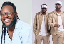 Clarence Peters’ Resurfaced Interview Sparks Fresh Debate Over P-Square’s Wealth Amid Financial Dispute Smiling man with glasses and dreadlocks in a light blue shirt photographed in a portrait.