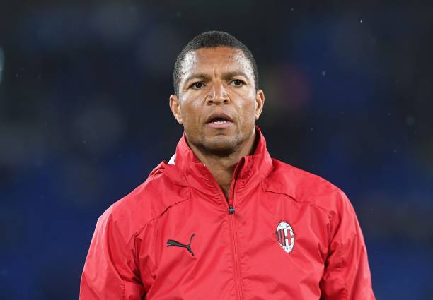 DIDA - THEWILL NEWS MEDIA Portrait of a man wearing a red AC Milan jacket with the club crest, standing outdoors and looking ahead.